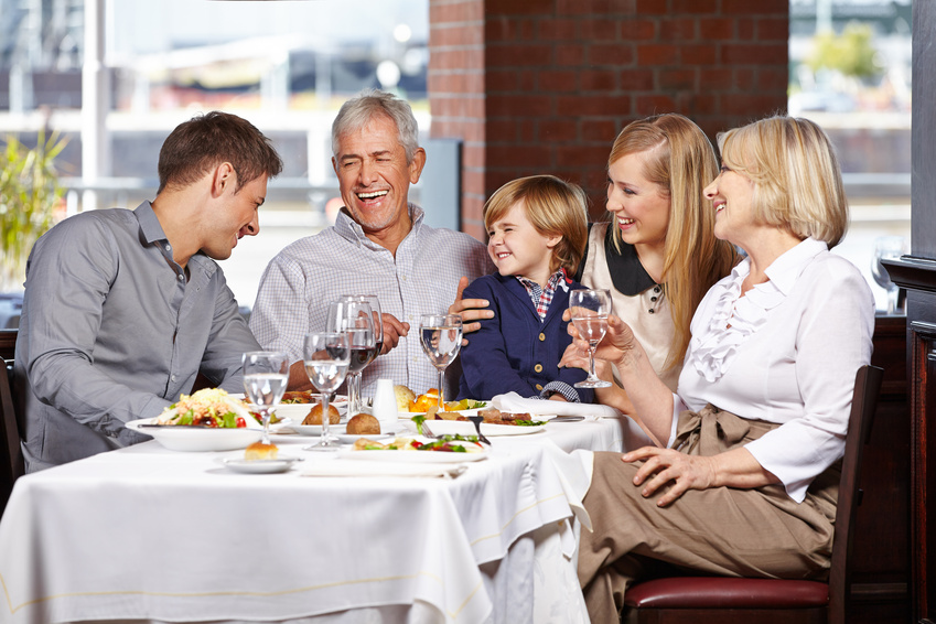 Happy family with child smiling together in a restaurant uroczystości biały dom